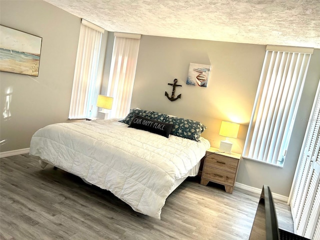 bedroom featuring a textured ceiling and wood-type flooring