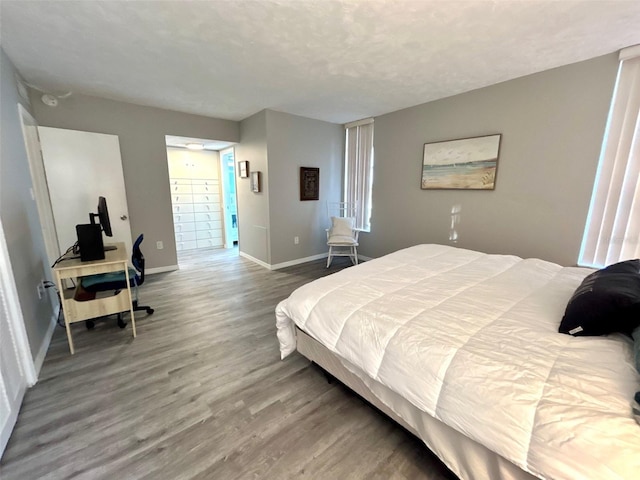 bedroom with hardwood / wood-style flooring and a textured ceiling