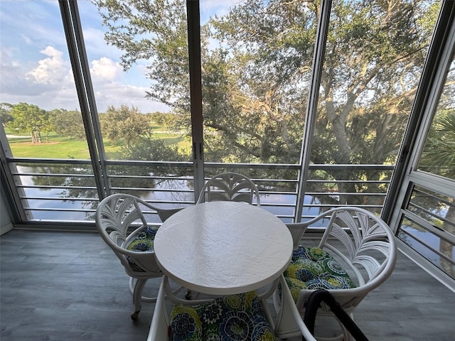 sunroom / solarium with a wealth of natural light and a water view