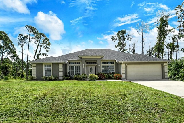 view of front of property featuring a front lawn and a garage