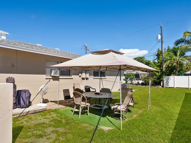 rear view of house featuring a lawn