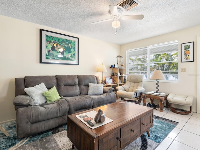 tiled living room with a textured ceiling and ceiling fan