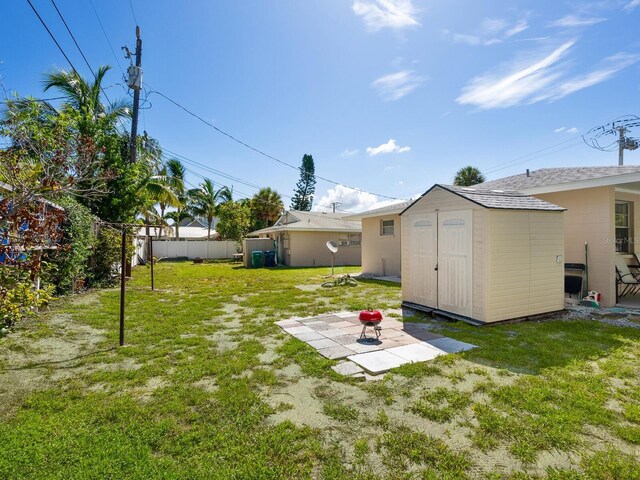 view of yard featuring a patio area and a storage shed