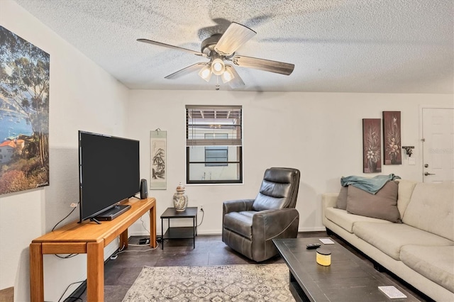 living room with ceiling fan and a textured ceiling