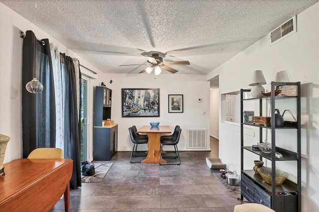 dining area featuring a textured ceiling and ceiling fan