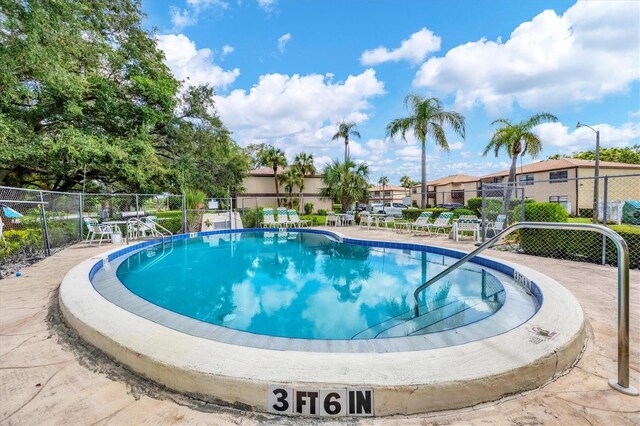 view of swimming pool featuring a patio