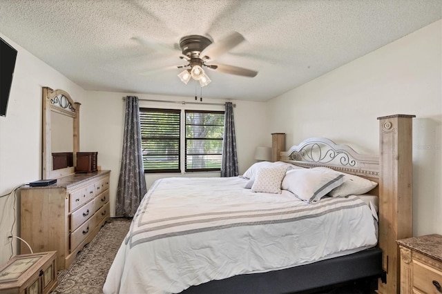 bedroom with a textured ceiling and ceiling fan