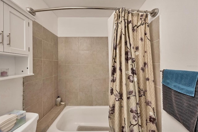 bathroom featuring shower / bath combo and toilet