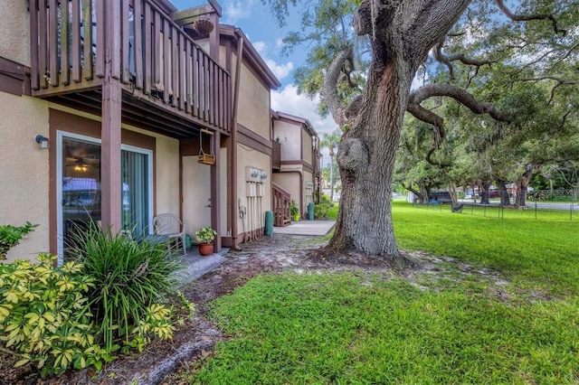 view of yard with a balcony