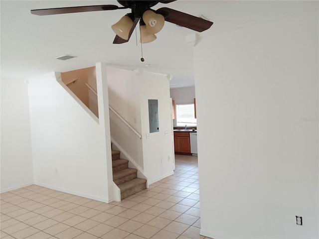 unfurnished room with visible vents, electric panel, light tile patterned floors, ceiling fan, and stairs