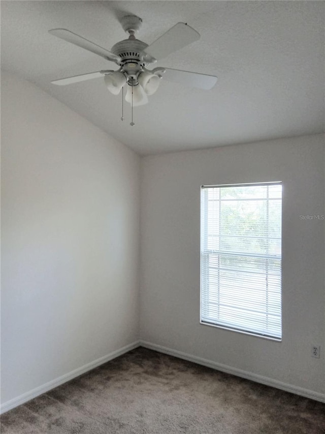 spare room featuring baseboards, carpet, and ceiling fan