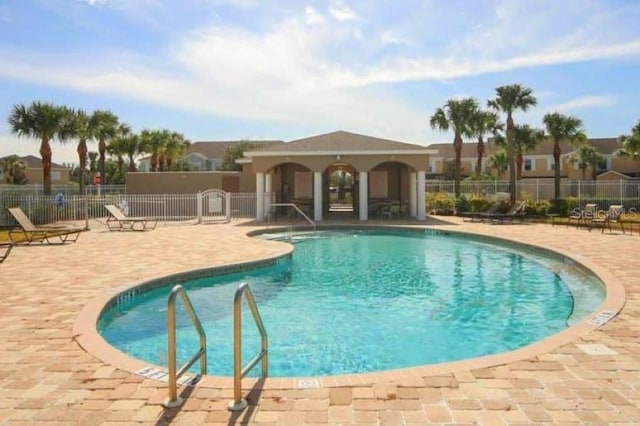 pool featuring a patio and fence