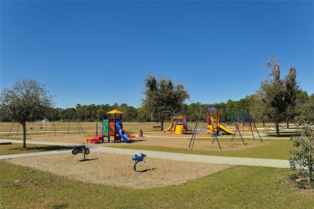 community jungle gym featuring a lawn