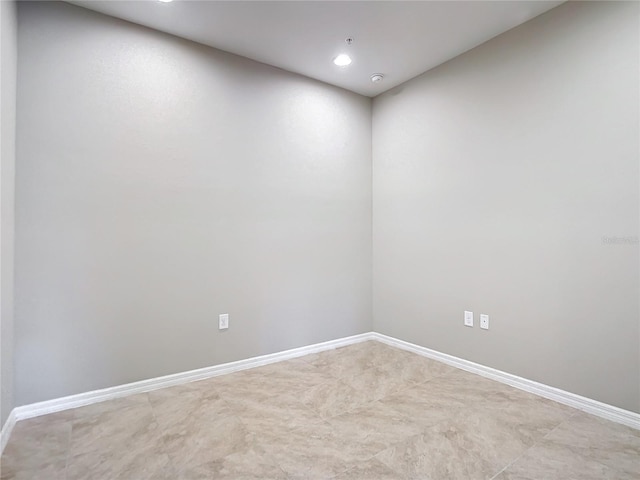 unfurnished room featuring baseboards