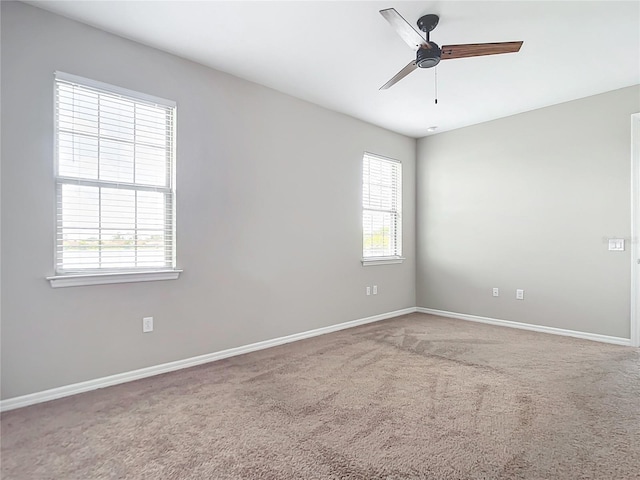 empty room featuring ceiling fan, baseboards, and carpet flooring