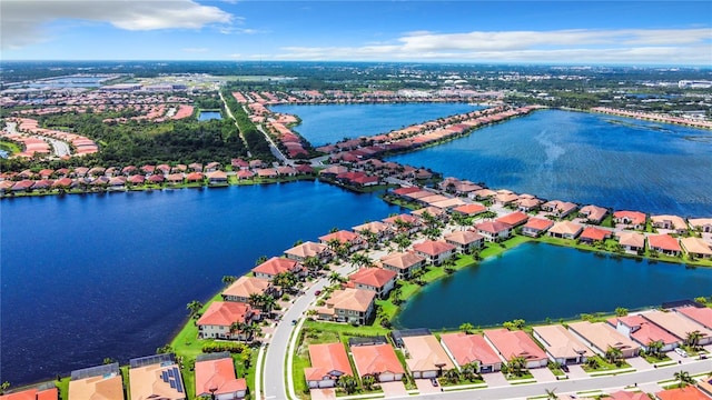 birds eye view of property with a water view and a residential view