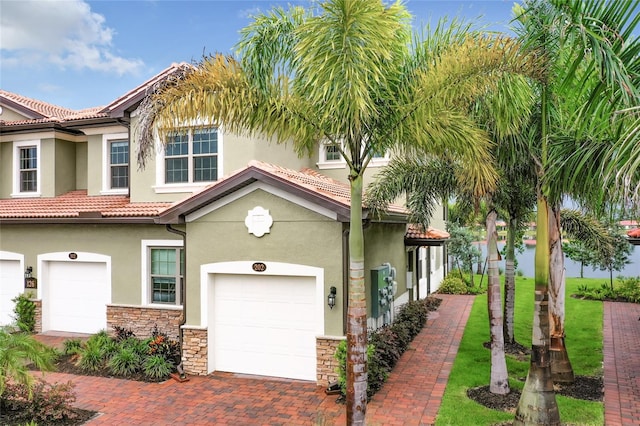 mediterranean / spanish house with a garage