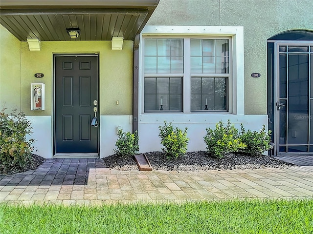 property entrance featuring stucco siding