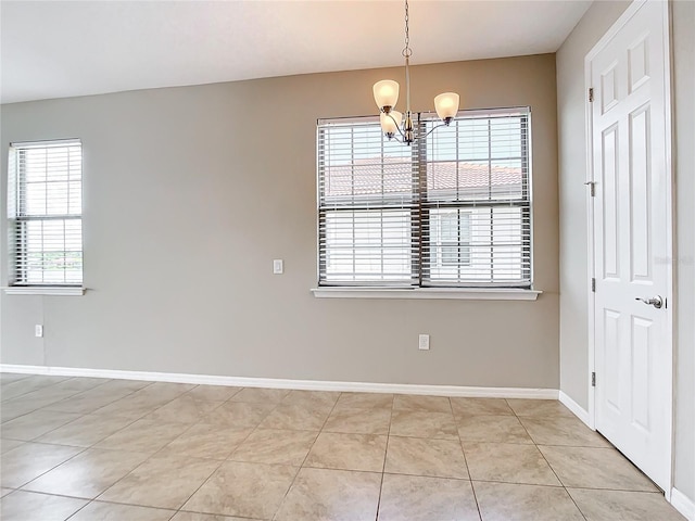 unfurnished room with light tile patterned floors and an inviting chandelier