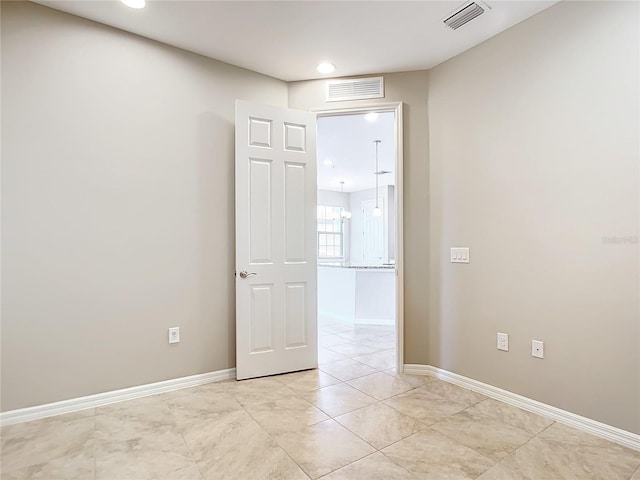 empty room featuring visible vents and baseboards