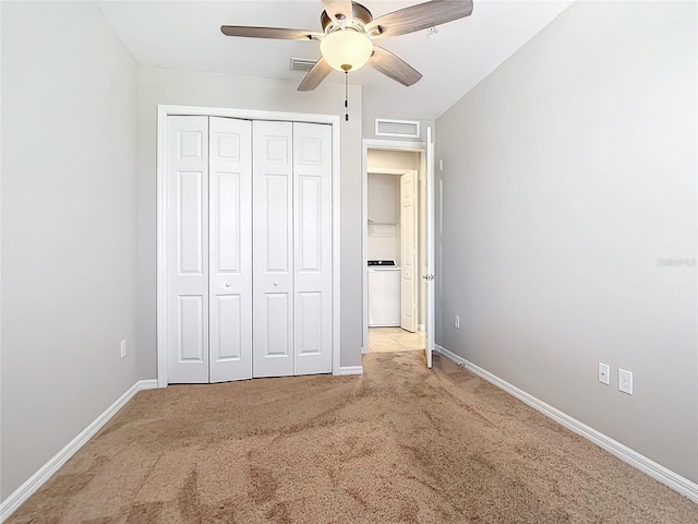 unfurnished bedroom featuring ceiling fan, light carpet, and a closet