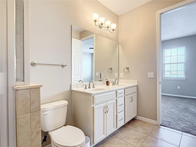 bathroom featuring tile patterned floors, double sink vanity, and toilet