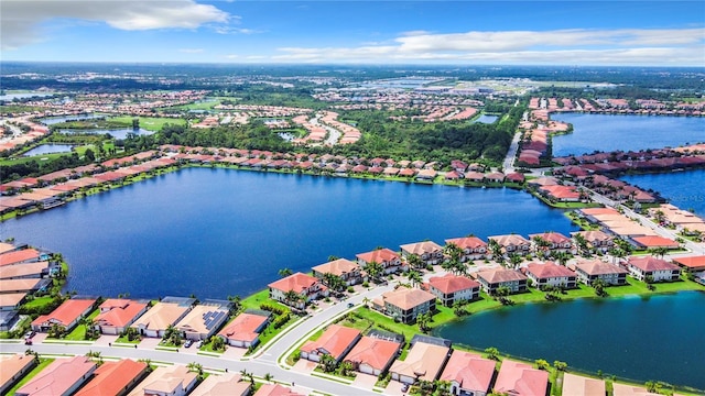 drone / aerial view featuring a water view and a residential view