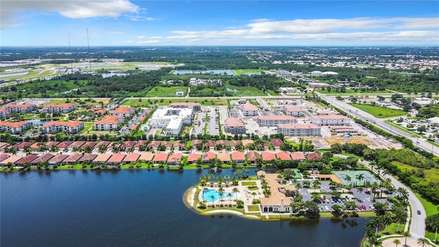 birds eye view of property with a water view and a residential view