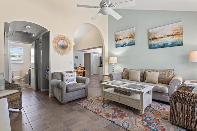 tiled living room featuring ceiling fan and lofted ceiling