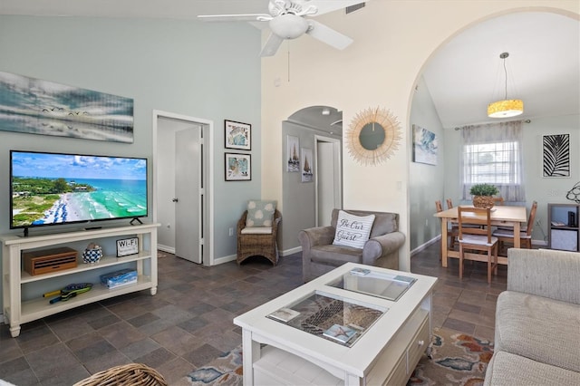 living room featuring ceiling fan and high vaulted ceiling