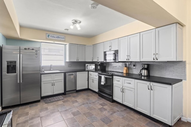 kitchen featuring tasteful backsplash, sink, stainless steel appliances, and tile patterned flooring