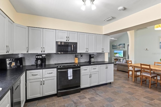 kitchen featuring white cabinets, electric stove, dark tile patterned floors, and decorative backsplash