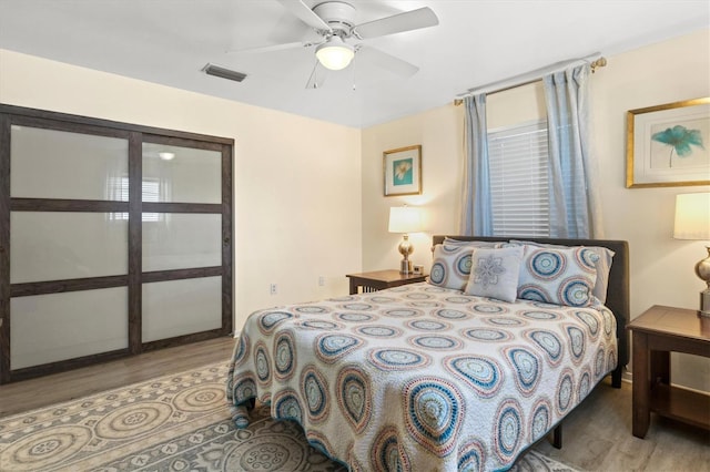 bedroom with ceiling fan and light hardwood / wood-style floors