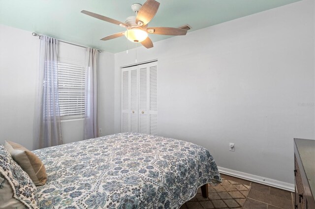 tiled bedroom featuring a closet and ceiling fan