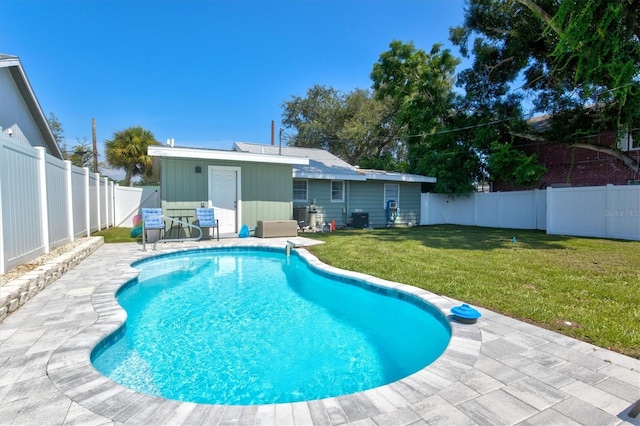 view of swimming pool with a lawn and a patio area