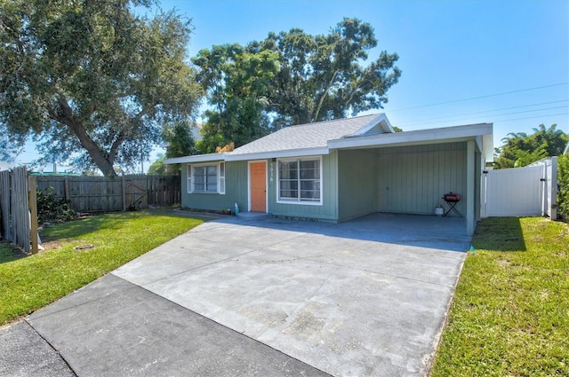 ranch-style house featuring a front lawn and a carport