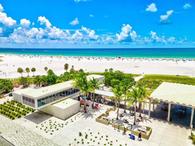 birds eye view of property featuring a water view and a view of the beach