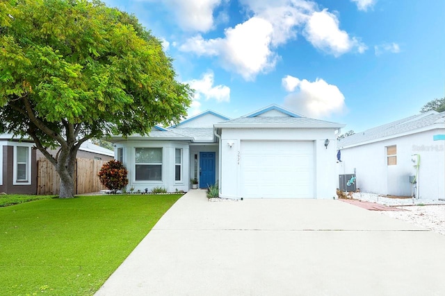 ranch-style house with a front lawn, a garage, and central AC