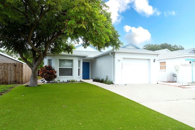 ranch-style house with an attached garage, fence, driveway, stucco siding, and a front yard