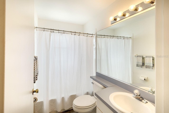 bathroom with toilet, shower / tub combo, and vanity