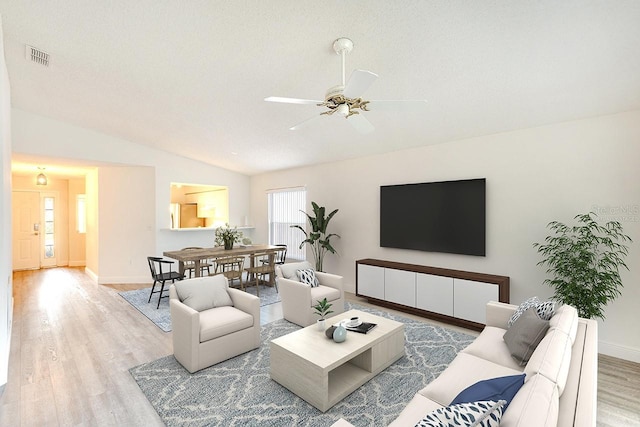 living room with light hardwood / wood-style floors, lofted ceiling, and ceiling fan