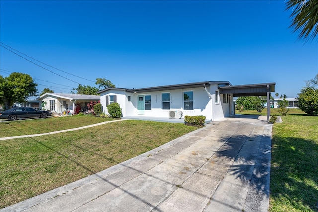 ranch-style home featuring a carport and a front lawn