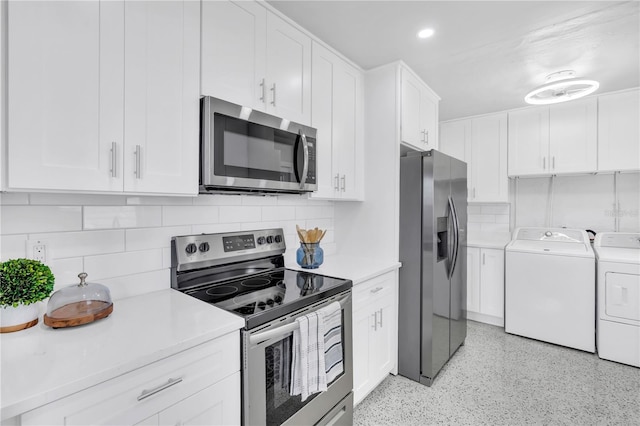 kitchen featuring white cabinetry, stainless steel appliances, washer and clothes dryer, and backsplash