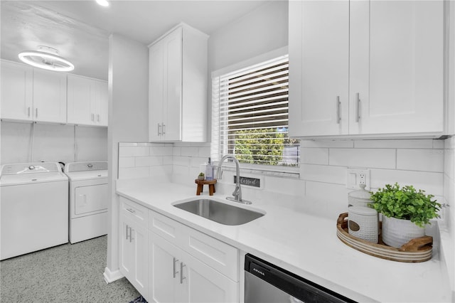 kitchen featuring tasteful backsplash, dishwasher, sink, white cabinets, and washing machine and dryer