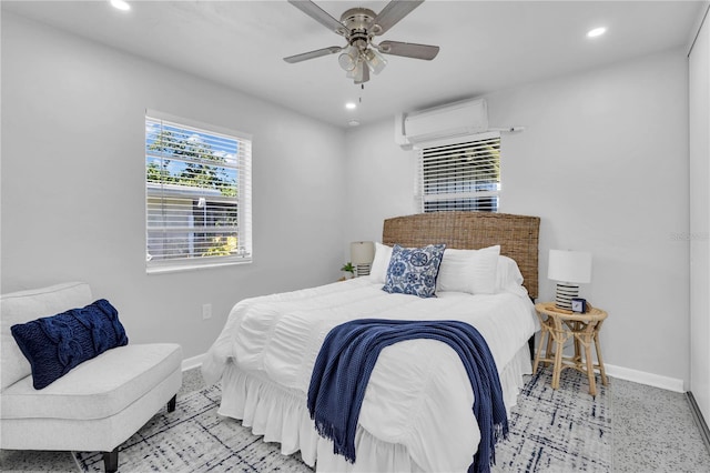 bedroom with a wall unit AC and ceiling fan