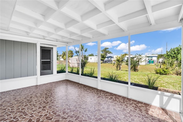 unfurnished sunroom with coffered ceiling and beam ceiling