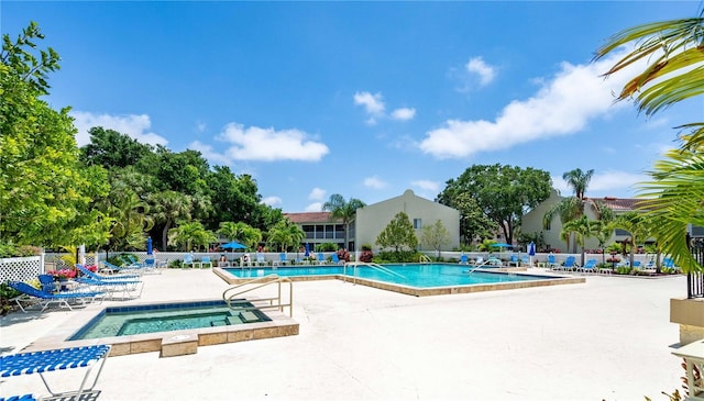 view of swimming pool featuring a community hot tub and a patio area