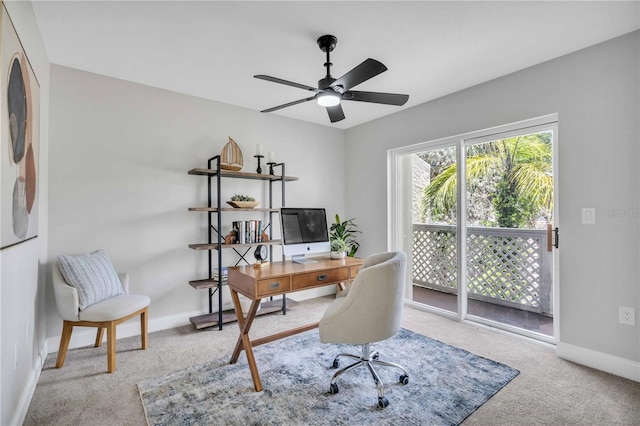 carpeted office space featuring ceiling fan