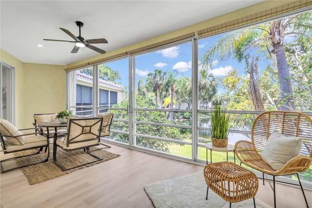 sunroom / solarium featuring ceiling fan