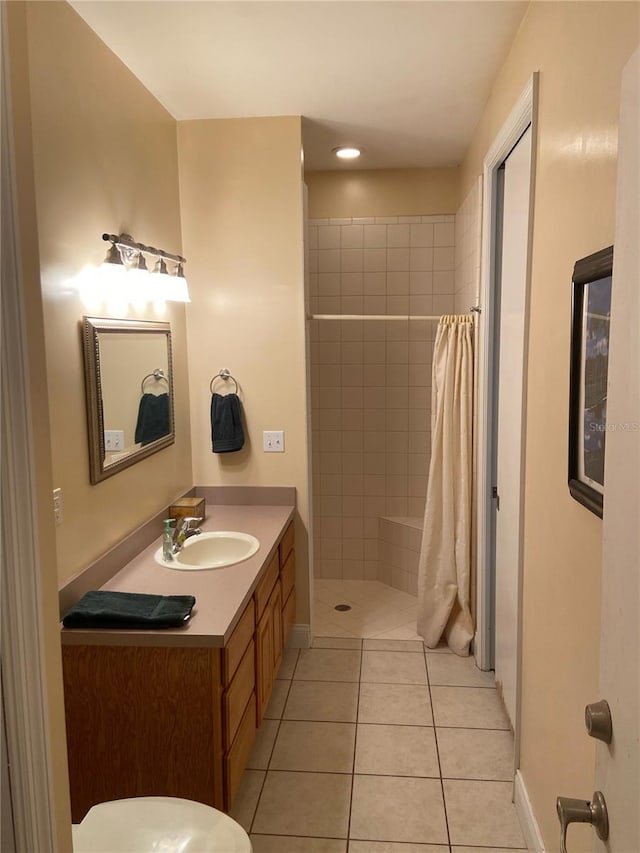 bathroom with a shower with curtain, vanity, and tile patterned flooring